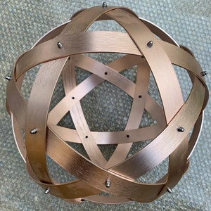 Genesa Pentasphere 32cm diameter brushed aluminum pink, 30mm wide bands, symmetrically intertwined fixed with gray cap nuts
