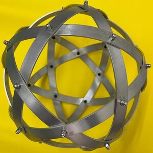 Genesa Pentasphere in Polished Natural Aluminium, 21 cm diameter with 15 mm wide bands, fixed with grey blind nuts