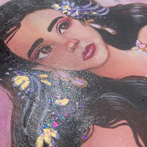 May include: A painting of a woman with long dark hair, wearing a purple and gold flower crown. The background is a soft pink.