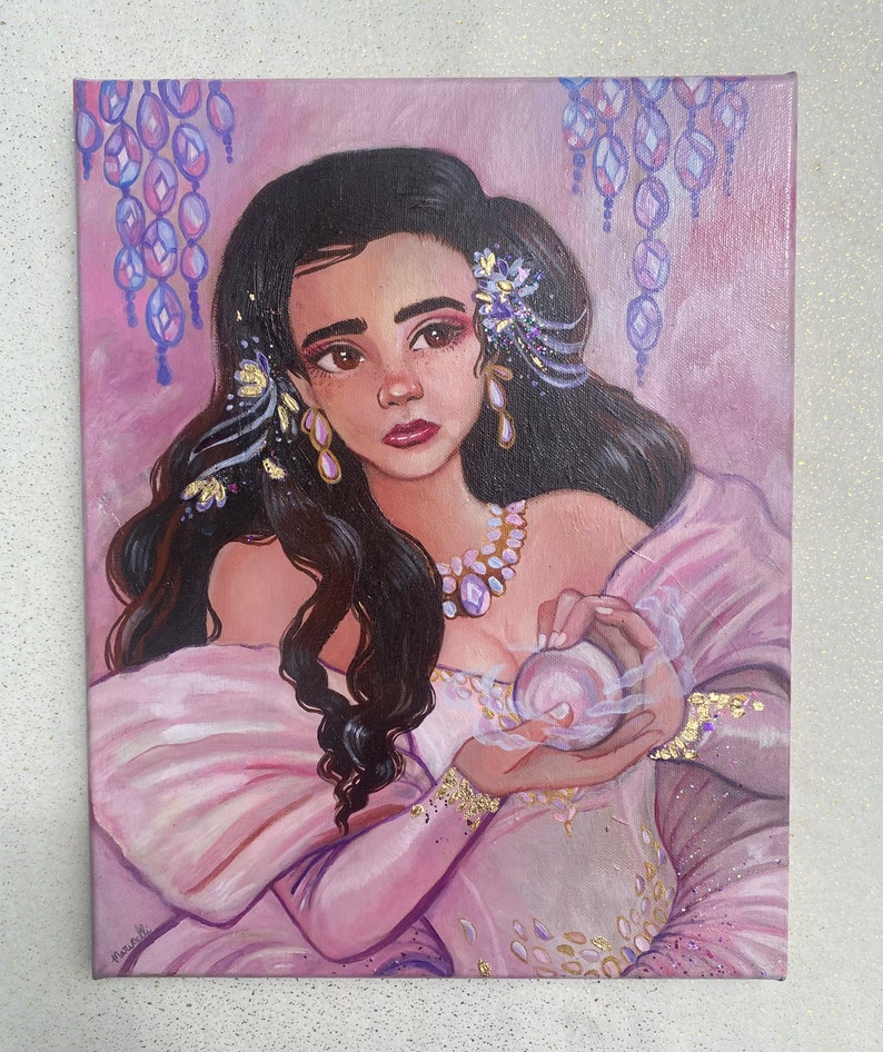 May include: A painting of a woman with long dark hair wearing a pink dress and holding a pearl in her hands. She is adorned with gold jewelry and flowers. The background is a soft pink with purple and gold accents.