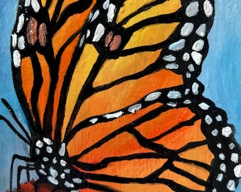 May include: A close-up painting of a monarch butterfly with orange, black, and white markings. The butterfly is perched on a purple flower against a light blue background. The artwork is detailed and vibrant.
