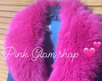 May include: A blue denim jacket with a large pink faux fur collar and cuffs. The jacket has a distressed look and the text "Pink Glam shop" and "Very full" is written on the front.