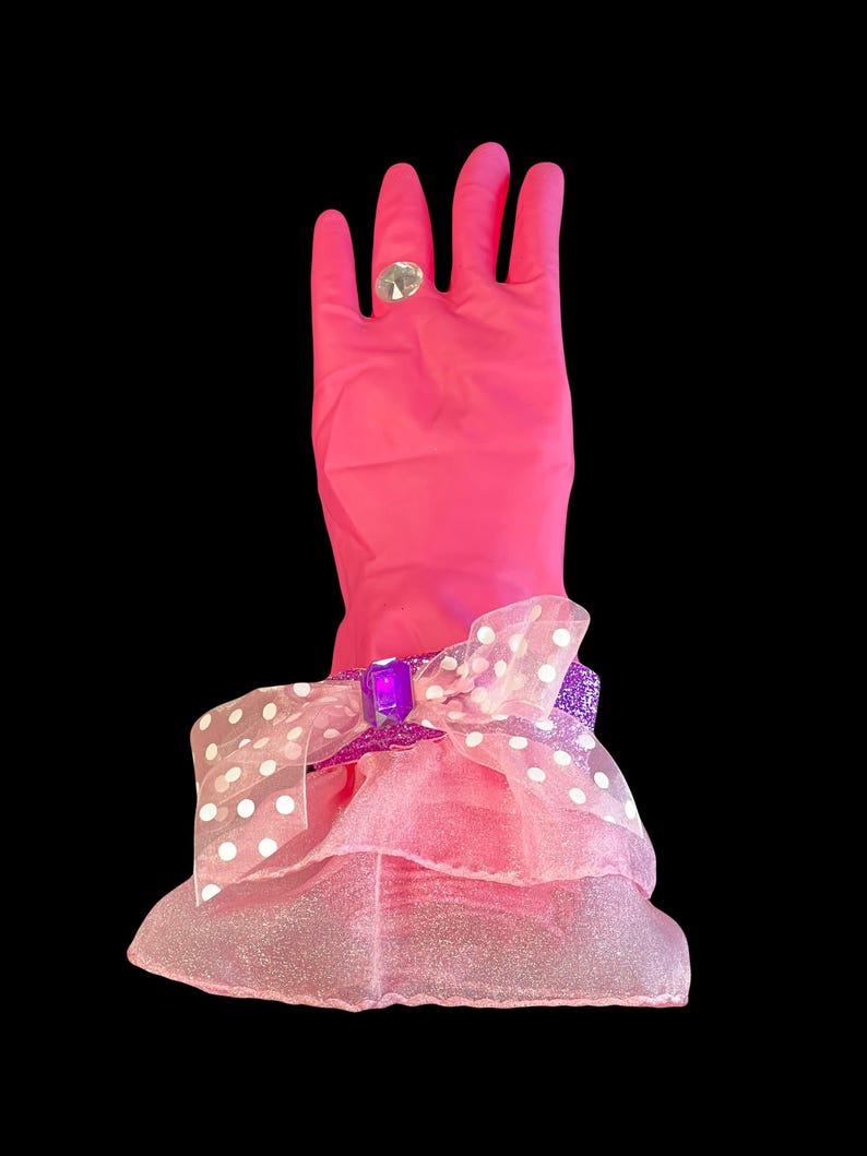 Pink dish washing gloves decorated with a light pink organza skirt, accent ribbon band around the wrist with a jewel on top, and completed with bling diamond ring. Valentine Favorite.