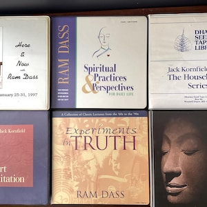 May include: A collection of six books on spirituality and meditation. The books are all different colors and have various titles, including "Here & Now with Ram Dass", "Spiritual Practices & Perspectives", "Experiments in Truth", "The Inner Art of Meditation", and "Chs Meditation".