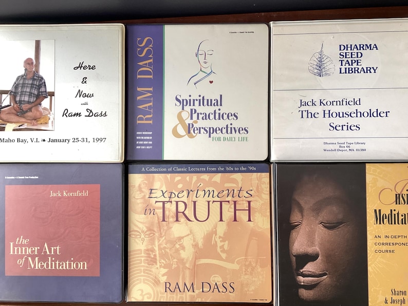 May include: A collection of six books on spirituality and meditation. The books are all different colors and have various titles, including "Here & Now with Ram Dass", "Spiritual Practices & Perspectives", "Experiments in Truth", "The Inner Art of Meditation", and "Chs Meditation".