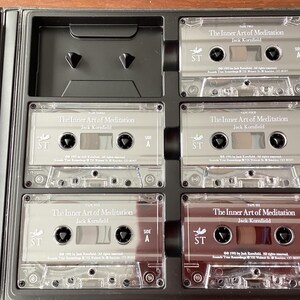 May include: A set of six silver cassette tapes labeled "The Inner Art of Meditation" by Jack Kornfield. Each tape is labeled with "Tape One" through "Tape Six" and has a side A and side B.