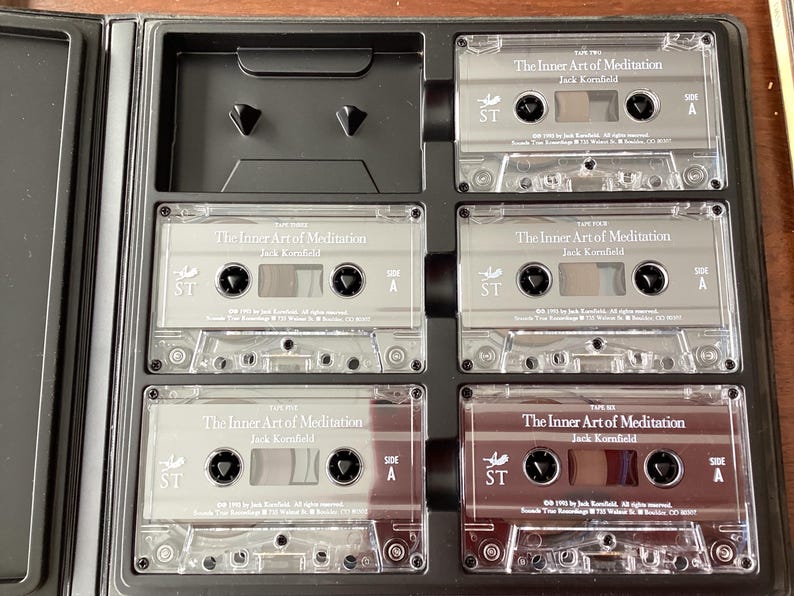 May include: A set of six silver cassette tapes labeled "The Inner Art of Meditation" by Jack Kornfield. Each tape is labeled with "Tape One" through "Tape Six" and has a side A and side B.