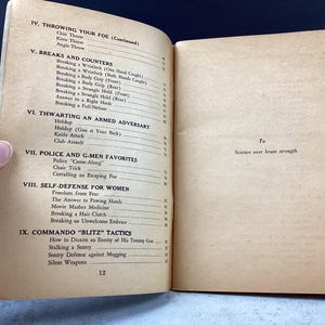 May include: Open vintage book pages with text on self-defense techniques. Sections include "Throwing Your Foe," "Breaks and Counters," and "Self-Defense for Women." The text is accompanied by page numbers and the phrase "Science over brute strength."