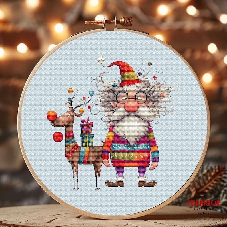 May include: Cross stitch pattern featuring a colorful Santa Claus with a white beard and glasses, holding a gift, and a reindeer with red pom-poms.