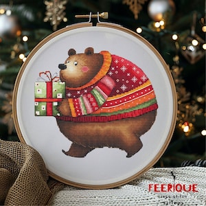 May include: A brown bear wearing a red, green, and white Christmas sweater holds a wrapped gift with a red bow. The bear is standing on a white background.