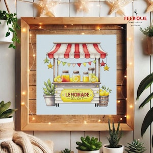 May include: A cross stitch pattern of a lemonade stand with a red and white striped awning, yellow lemons, and a sign that says "Lemonade Delight".
