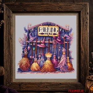 May include: A framed cross-stitch embroidery featuring a collection of colorful witch hats and brooms hanging against a dark blue background. A central sign with a yellow border displays the text PARKING HERE in black, stylized lettering.