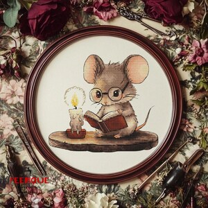 May include: A brown mouse wearing round glasses sits on a wooden surface and reads a book by candlelight.