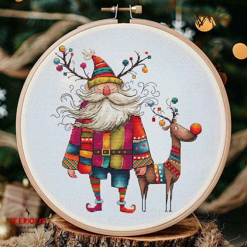May include: A colorful cross-stitch pattern featuring a whimsical Santa Claus with a long white beard and a reindeer with a red nose. The Santa Claus is wearing a multi-colored sweater and pants, and the reindeer is wearing a colorful patterned scarf. Both figures have antlers adorned with colorful ornaments.