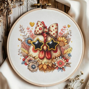 May include: A cross-stitch embroidery hoop with a colorful illustration of a chicken wearing sunglasses and a bow. The chicken is surrounded by flowers and leaves.