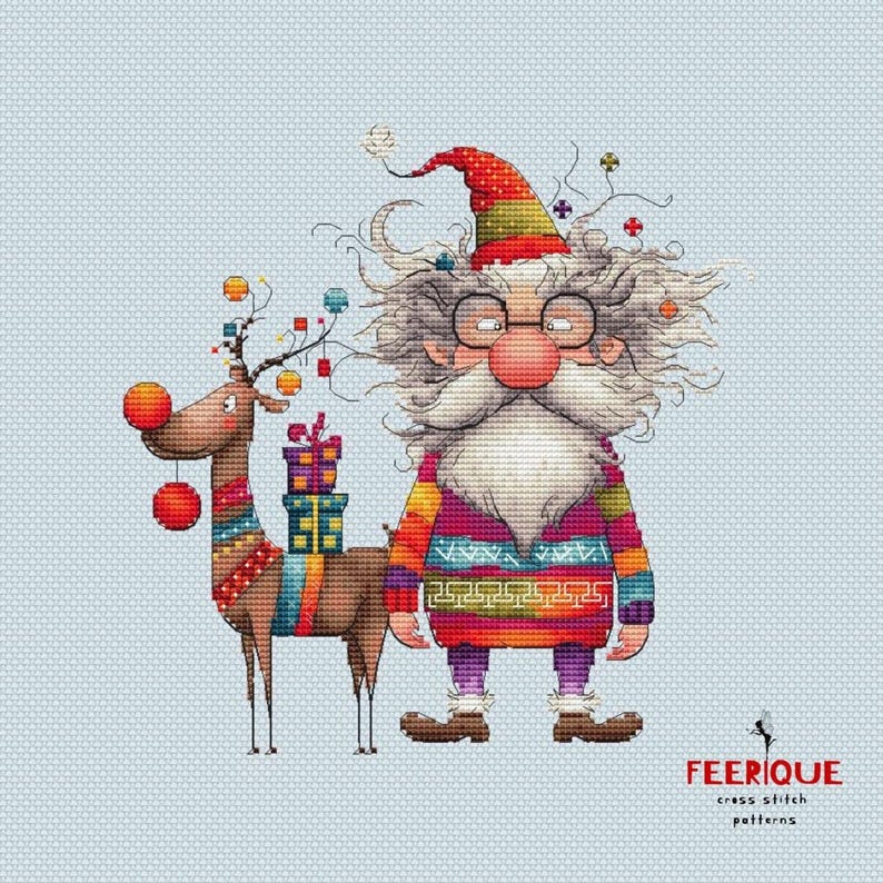 May include: A cross stitch pattern featuring a whimsical Santa Claus with a long white beard and a reindeer with red ornaments. The Santa Claus is wearing a colorful sweater and a red hat. The pattern is titled "FEERIQUE cross stitch patterns".