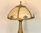 Antique Art Nouveau Carmel Slag Glass Table Lamp Featuring Golden Bronze Base And Elegant Swirling Designed Panels