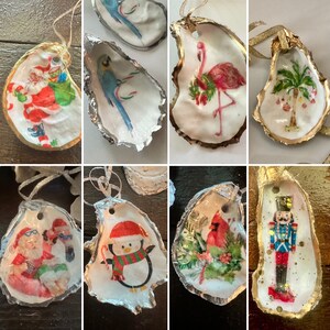 May include: Nine oyster shell ornaments with various holiday themes.  The ornaments feature a Santa Claus, a penguin, a nutcracker, a flamingo, a palm tree, a cardinal, and a blue jay.