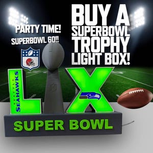 May include: A Super Bowl trophy light box with the text "BUY A SUPERBOWL TROPHY LIGHT BOX!". The light box features the Seattle Seahawks logo, the Roman numeral "LX", and a football. The words "SUPER BOWL" are also displayed.