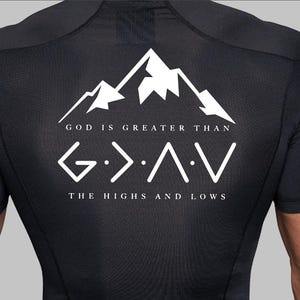 May include: Black compression shirt with white mountain graphic and the text "GOD IS GREATER THAN G>A>V THE HIGHS AND LOWS". The shirt is short-sleeved and has a crew neck.