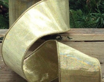 May include: A roll of wide, shimmering gold ribbon with a textured surface and a stitched edge. The ribbon is partially unrolled, revealing its width and the subtle variations in its color. Ideal for crafting and gift wrapping.