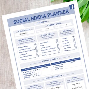May include: A printable social media planner with a blue and white color scheme. The planner includes sections for today's date, business goals, social goals, time goals, posting strategy, content strategy, and notes. The planner is designed to help users plan and track their social media activities.
