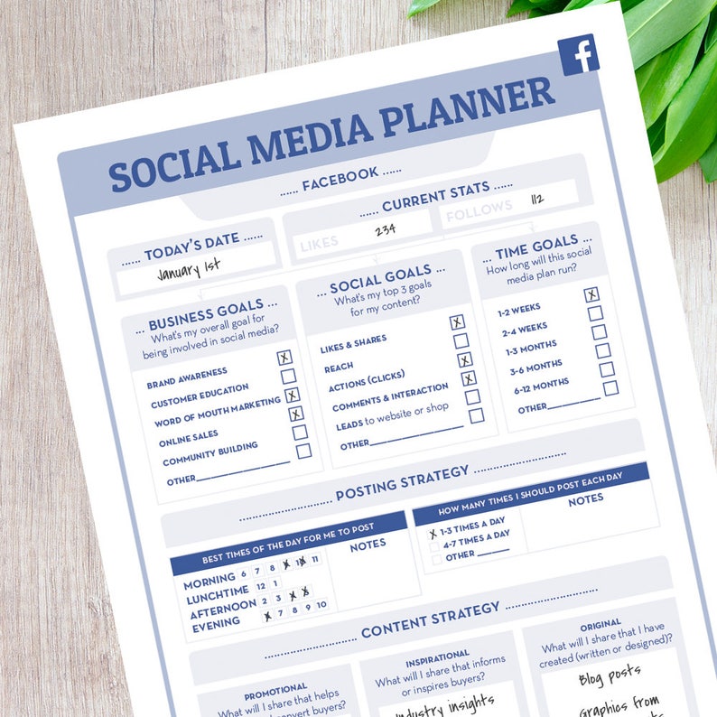 May include: A printable social media planner with a blue and white color scheme. The planner includes sections for today's date, business goals, social goals, time goals, posting strategy, content strategy, and notes. The planner is designed to help users plan and track their social media activities.
