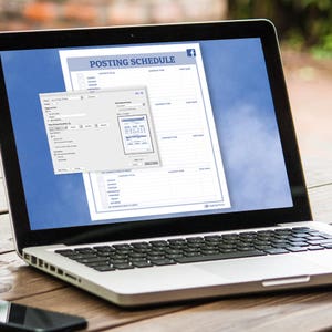 May include: A laptop computer with a white case and a black keyboard. The screen displays a document titled "Posting Schedule" with a Facebook logo in the top right corner. The document is a grid with columns for "Content Type", "Content Brief", "Scheduled Time", and "Post Date".