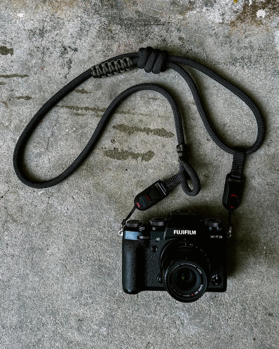 Black adjustable camera rope strap with quick release attachments