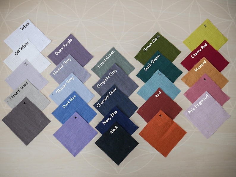 May include: A collection of square fabric swatches arranged in a grid, featuring a wide variety of colors including white, off-white, dusty purple, neutral grey, natural linen, forest green, moss, cherry red, mustard, rust, navy blue, and black.