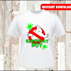 May include: White t-shirt with a red circle and a diagonal red line through it. Inside the circle is a white ghost with green slime dripping from it. The text "Birthday Boy" is written in green below the circle.