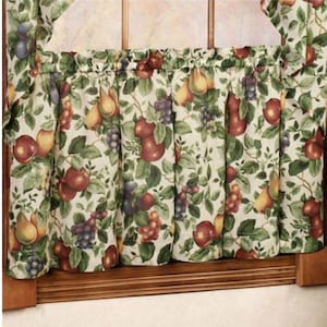 May include: A white valance with a fruit print featuring pears, apples, grapes, and leaves. The valance has a gathered ruffle at the top.