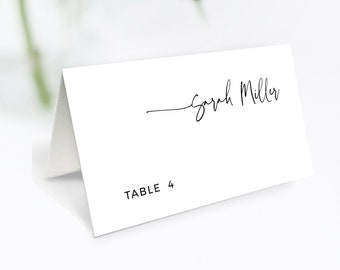 May include: White place card with black text. The text reads "Sarah Miller" and "TABLE 4".