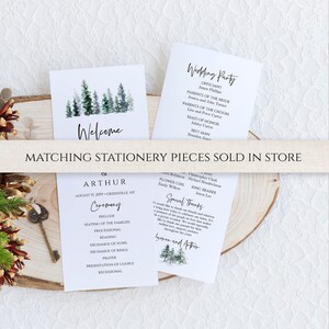 May include: A wedding ceremony program with a watercolor illustration of pine trees. The program includes the order of events for the ceremony, including the prelude, seating of the families, processional, reading, exchange of vows, exchange of rings, prayer, presentation of couple, and recessional. The program also includes the date and location of the ceremony.
