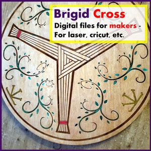 May include: A wooden circle with a brown and red Brigid Cross design. The cross is surrounded by green vines with teal leaves. The text "Brigid Cross" is at the top of the circle. The text "Digital files for makers - For laser, Cricut, etc." is below the cross.