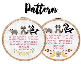 May include: Two embroidery hoop patterns with white fabric and pink text that reads "Support Your Local Street Gang". The left hoop features a raccoon, a skunk, and a possum. The right hoop features a raccoon, a skunk, and a trash can with bananas.