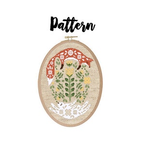 May include: A cross-stitch pattern featuring a fox and a rabbit in a circle of flowers. The pattern is framed in a wooden hoop.