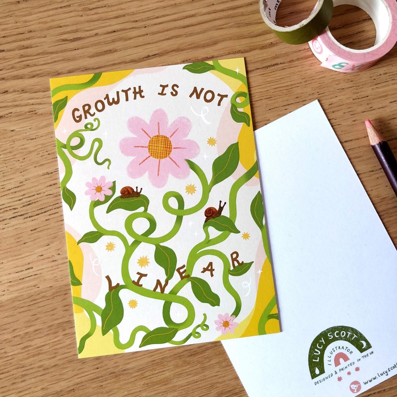 May include: Greeting card with the text "GROWTH IS NOT LINEAR" in a whimsical font. The card features a pink flower, green vines, and small snails. The background is white with yellow and pink accents.