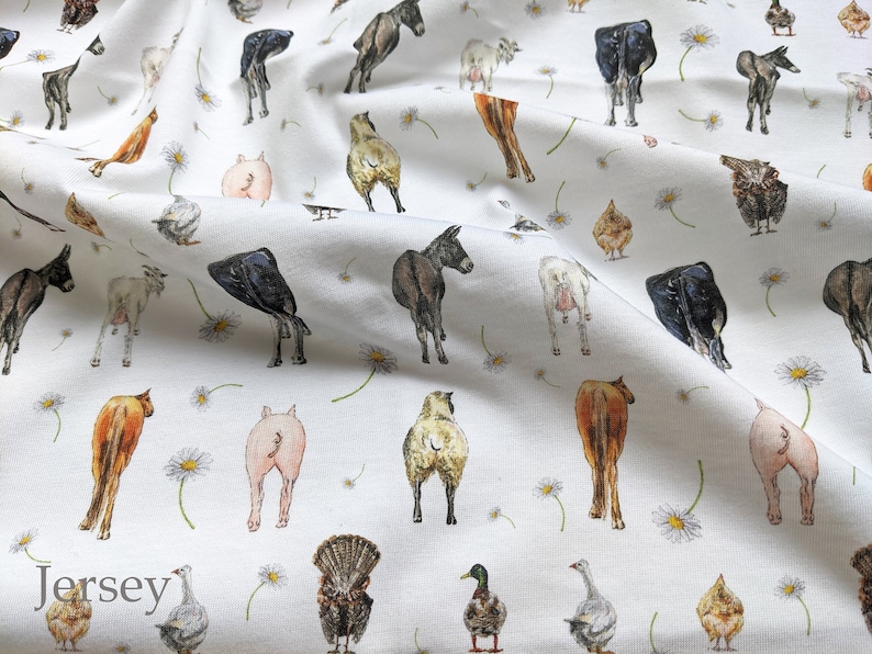 May include: White fabric with a repeating pattern of farm animals, including cows, pigs, chickens, goats, donkeys, and a turkey. The animals are all facing away from the viewer and are drawn in a cartoon style. The fabric is printed with the word "Jersey" in the bottom left corner.