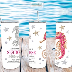 May include: White stainless steel tumblers with seahorse and starfish designs. One tumbler features a silver seahorse, another a gold seahorse, and the last a pink seahorse. Text includes "Advice from a Seahorse".