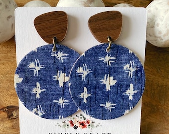 May include: A pair of blue and white patterned earrings with wooden tops. The earrings are displayed on a white card with the text "SIMPLY GRACE by Dakota Country Designs dakotacountrydesigns.etsy.com".