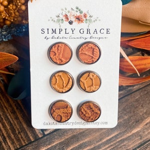 May include: Set of six brown leather earrings with a silver backing. The earrings are displayed on a white card with the text "SIMPLY GRACE by Dakota Country Designs" and the website address "dakotacountrydesigns.etsy.com".