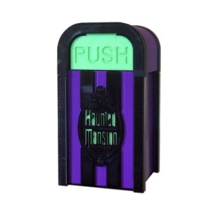 May include: A purple and black striped trash can with a green "PUSH" button and a black "Haunted Mansion" logo.