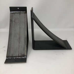 four inch wide shelf support brackets with a four inch wide curved support bar. Made from hot rolled steel. The pictured set is raw unfinished metal. There are several finishes available allowing the customer to find the perfect look