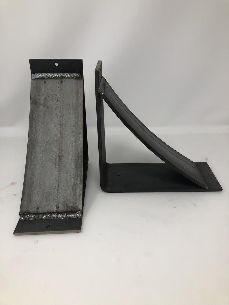 four inch wide shelf support brackets with a four inch wide curved support bar. Made from hot rolled steel. The pictured set is raw unfinished metal. There are several finishes available allowing the customer to find the perfect look