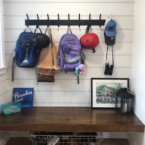 Front entry way backpack holder rack