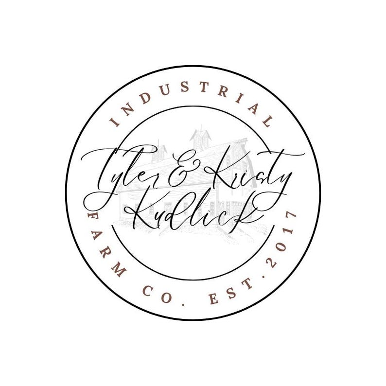 May include: A circular logo featuring a thin black outline. Inside, a faint line drawing of a barn sits behind the brown text Tyler & Kristy Kudlick. The words INDUSTRIAL FARM CO. EST. 2017 are written in brown capital letters along the inner border.