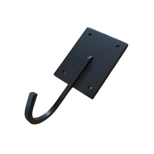 May include: Black metal wall hook with a square base and a curved hook. The hook is attached to the base with four screws.