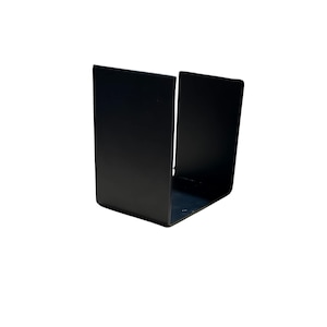 May include: Black metal napkin holder with a simple, open design. The holder is made of sturdy metal and has a sleek, modern look.