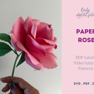 May include: A handmade paper rose in shades of pink, with green leaves and stem. The image includes the text "PAPER ROSE" and "Only digital file!" on a pink background. Tutorials and patterns are available.
